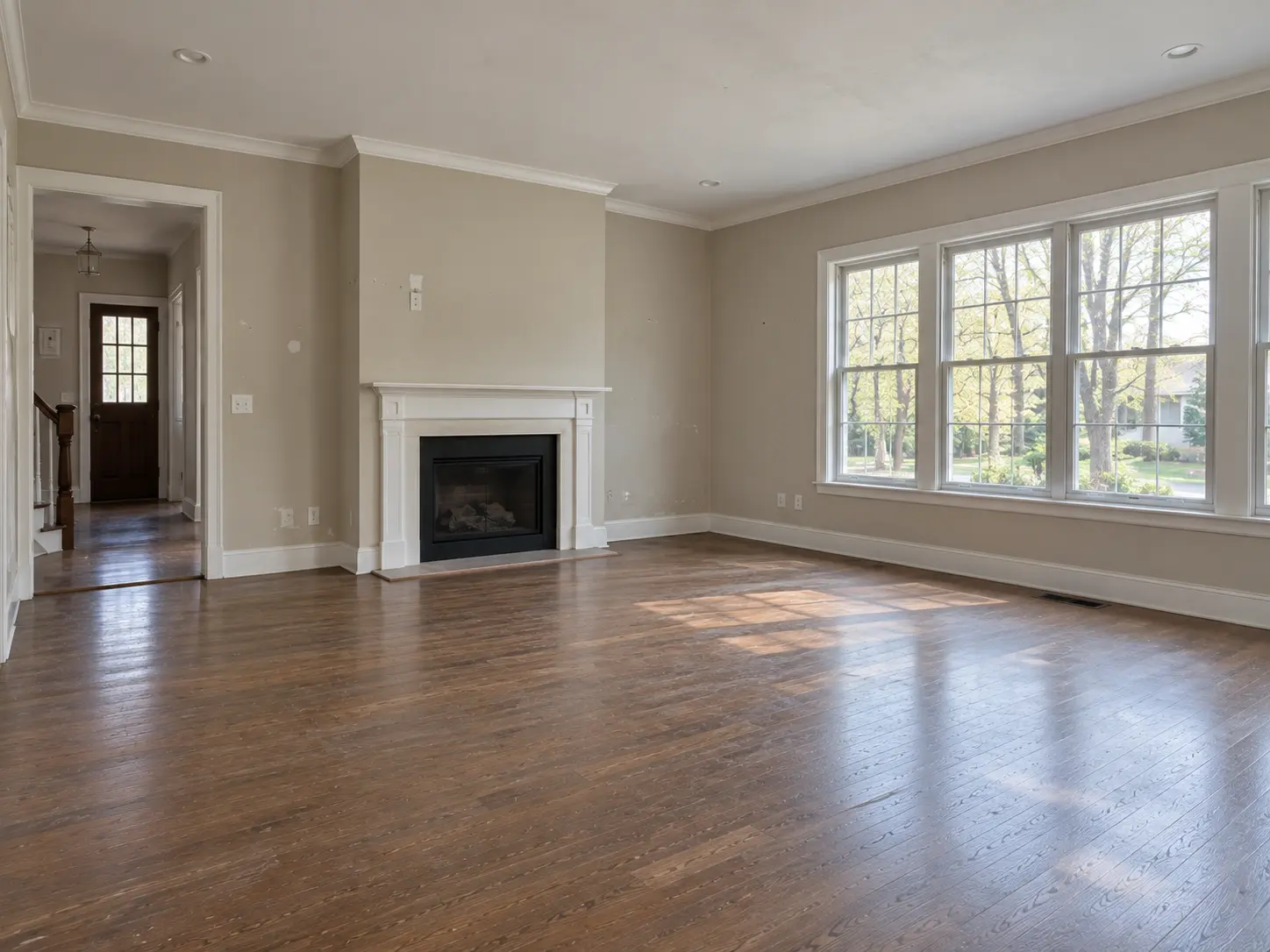 Empty living room with fireplace and windows