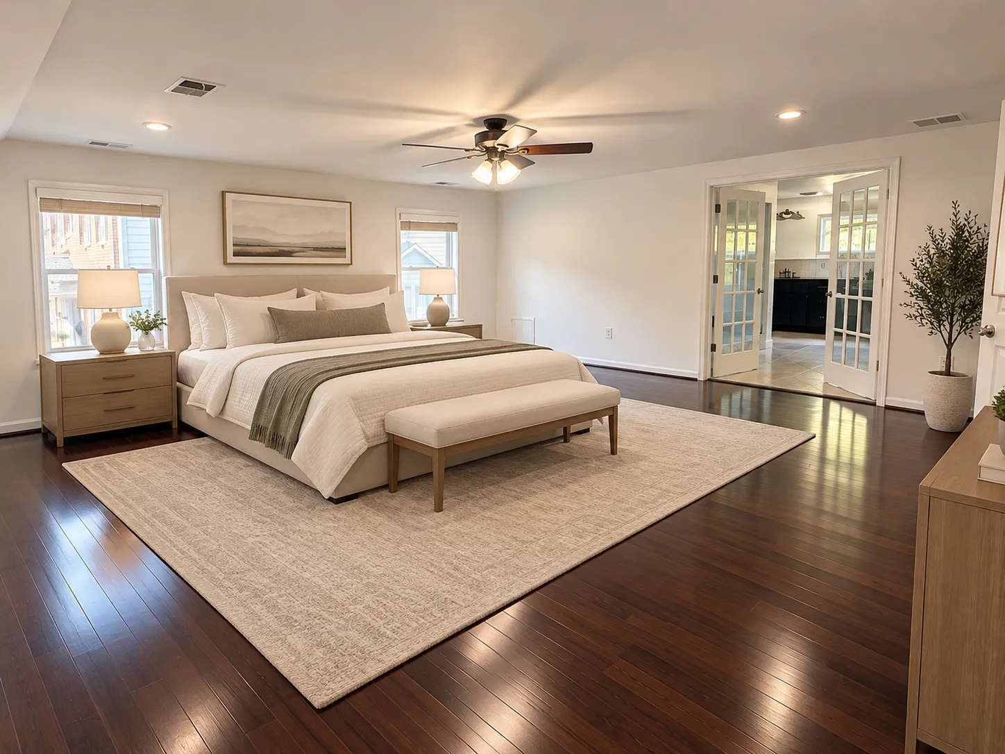 Partially staged bedroom with layered bedding